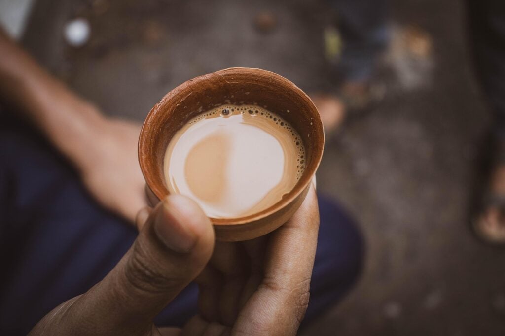 A small rustic handle-free teacup with creamy, thick butter tea from Tibet.