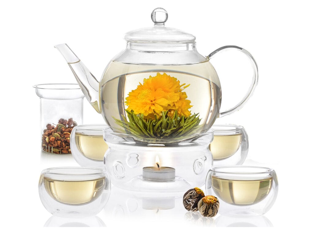 Teabloom’s Celebration borosilicate glass tea pot set with infuser, blooming teas, teacups, teapot, and tea warmer