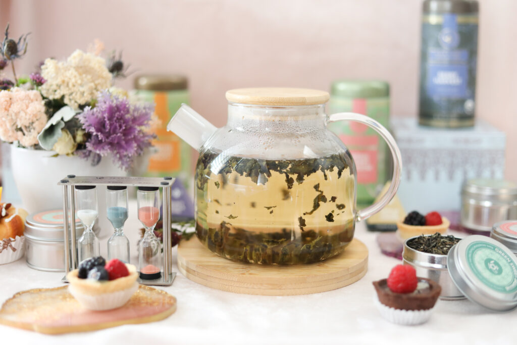 How to make oolong tea in a teapot with fruit tarts and a sand tea timer. 