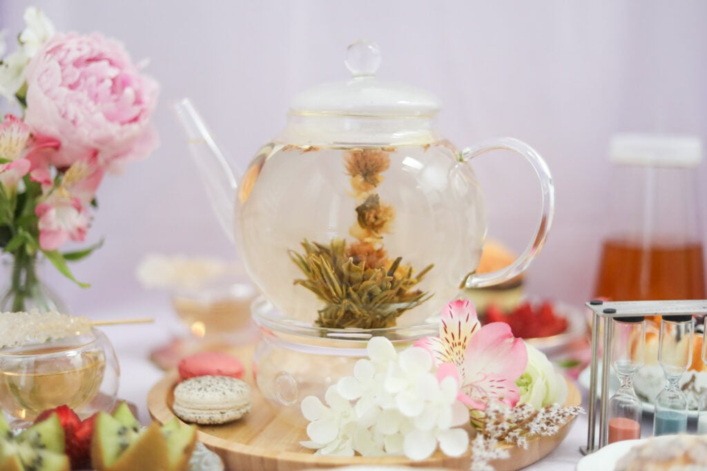 Sustainable teapot with blooming tea and flowers