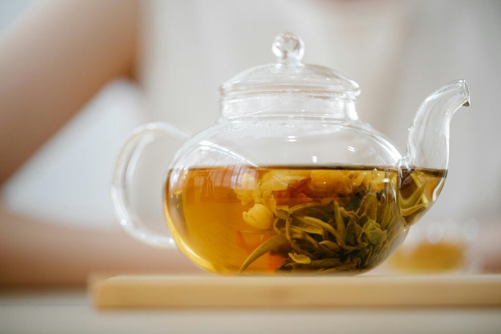 Flowering tea in glass teapot as one of the benefits of antioxidants in tea