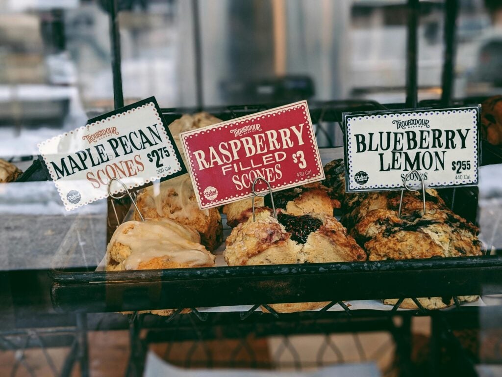 Freshly baked scones in a window display basket as inspiration for holiday tea party ideas.