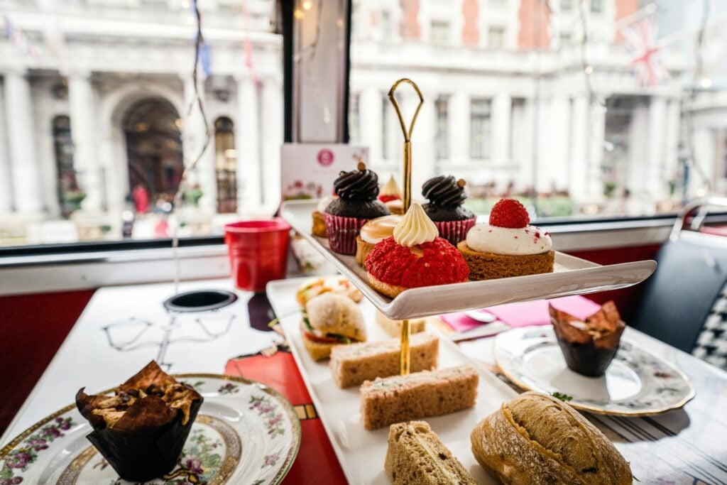 Holiday afternoon tea party tiered tea stand with sweets and sandwiches.