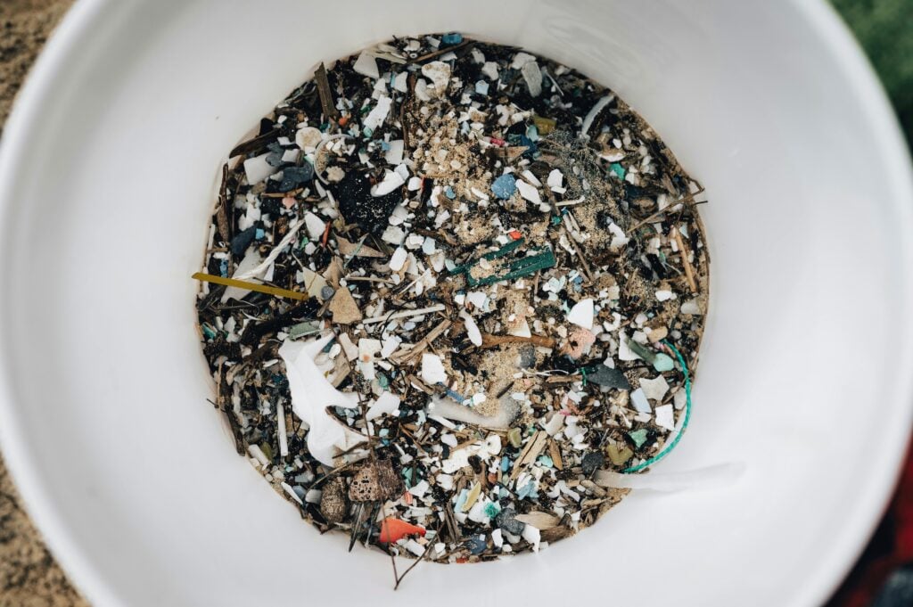 A bowl full of small plastic debris is an example of microplastics.