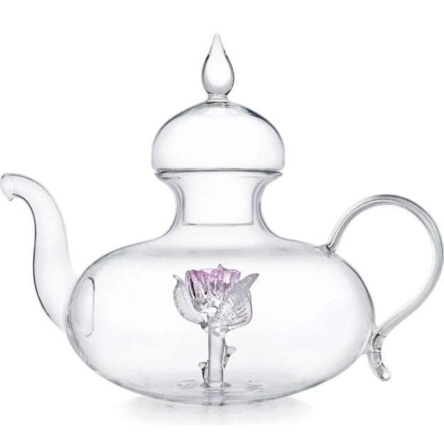 An elegant glass teapot with a light pink rose sculpture in the center.