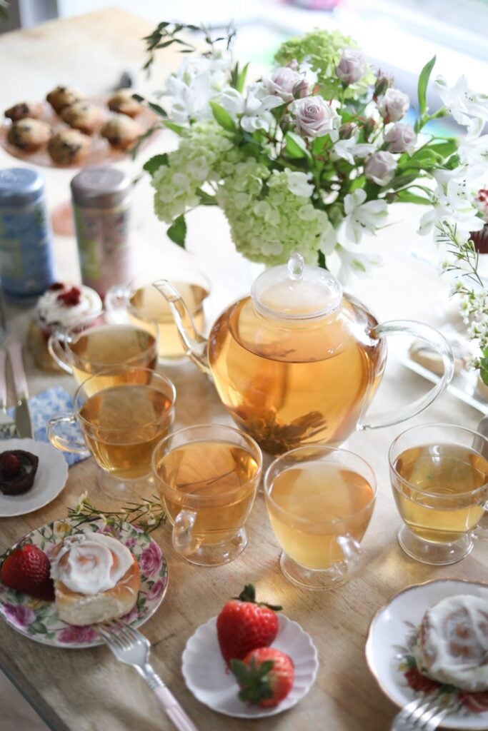 Teabloom’s Grand Bouquet is one of the best tea sets, with six teacups on a table with flowers, fruit, and pastries.